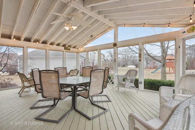 sunroom with lofted ceiling with beams and ceiling fan