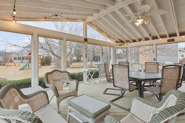 sunroom featuring plenty of natural light, vaulted ceiling with beams, and ceiling fan