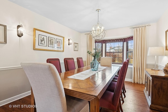 dining space with dark hardwood / wood-style floors and a chandelier