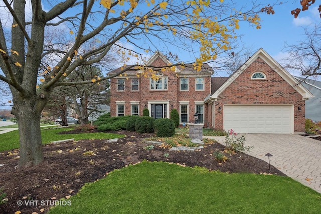 view of front of property featuring a garage and a front yard