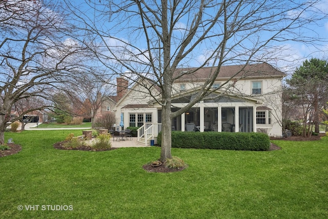 back of house featuring a sunroom, a lawn, and a patio area