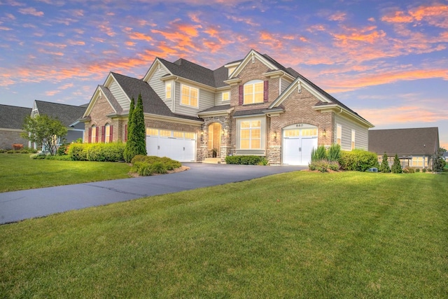 view of front of house with a yard and a garage