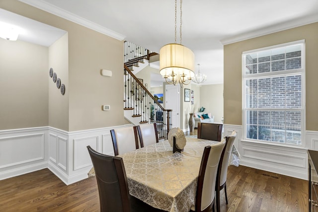 dining area with a chandelier, crown molding, and dark hardwood / wood-style floors