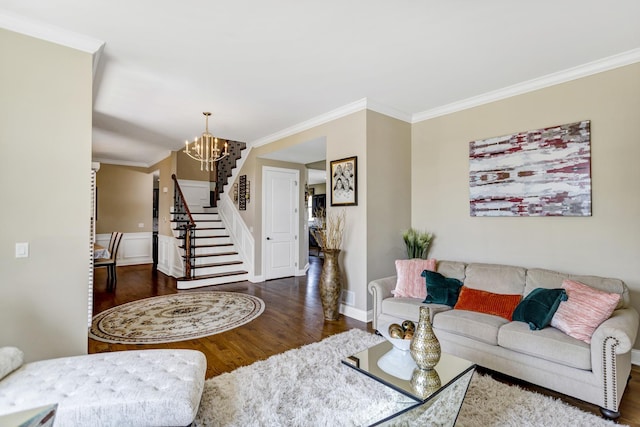 living room featuring ornamental molding, a chandelier, and dark hardwood / wood-style floors