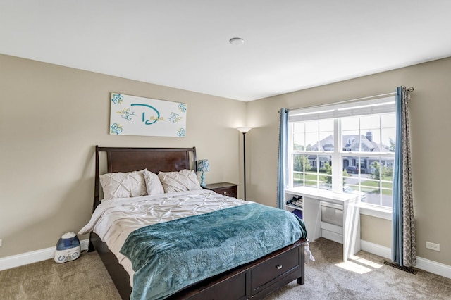 bedroom featuring light carpet