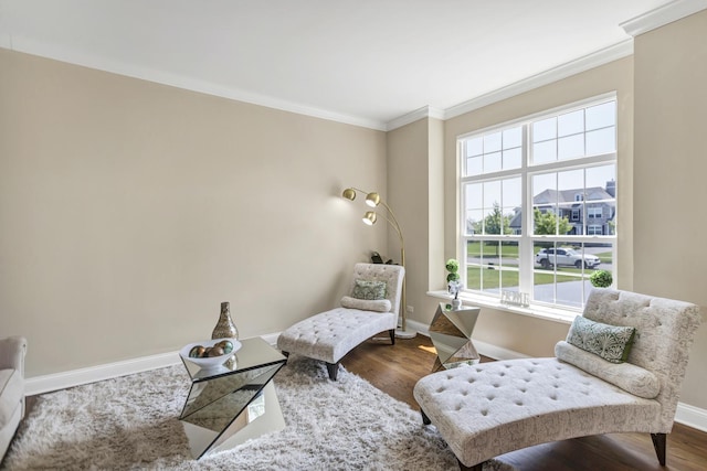 sitting room with hardwood / wood-style flooring and ornamental molding