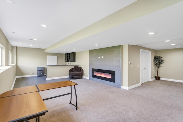 living room with a large fireplace and light carpet