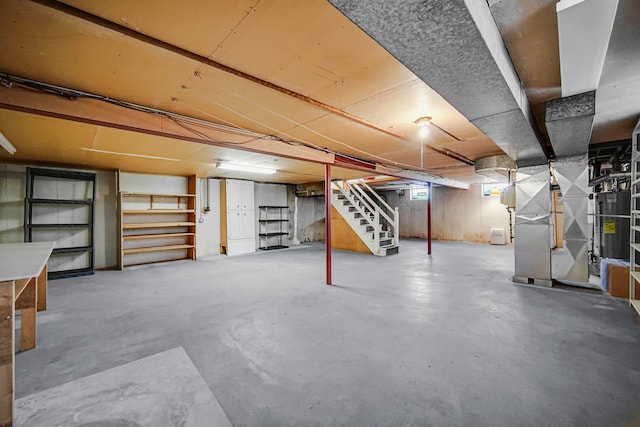 unfinished basement with heating unit and stairway