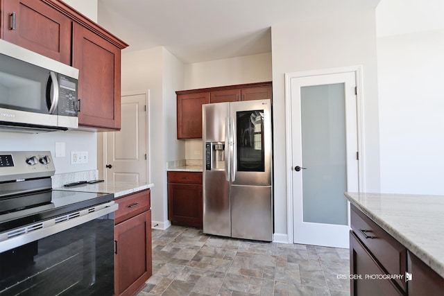 kitchen with light stone counters and stainless steel appliances