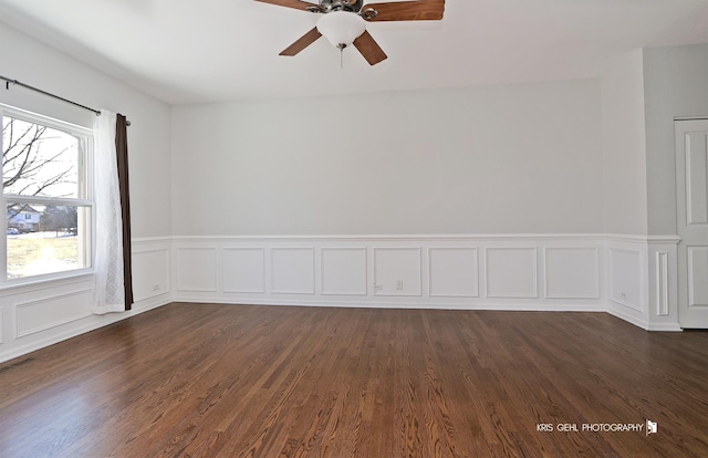 empty room with dark wood-type flooring, ceiling fan, and a healthy amount of sunlight