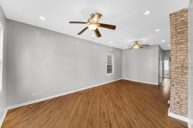 unfurnished living room featuring wood-type flooring and ceiling fan