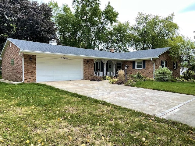 ranch-style home featuring a garage, driveway, a front yard, and brick siding