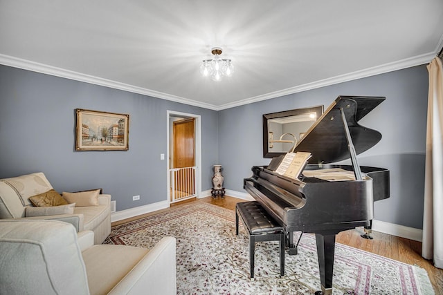 sitting room with crown molding and light hardwood / wood-style floors