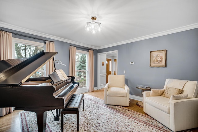 sitting room with crown molding and light wood-type flooring