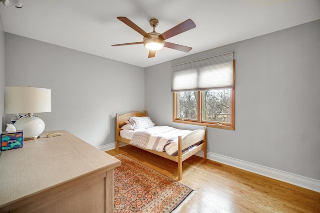 bedroom with ceiling fan and light hardwood / wood-style flooring