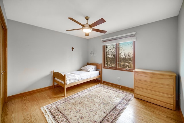 bedroom featuring light hardwood / wood-style floors, a closet, and ceiling fan