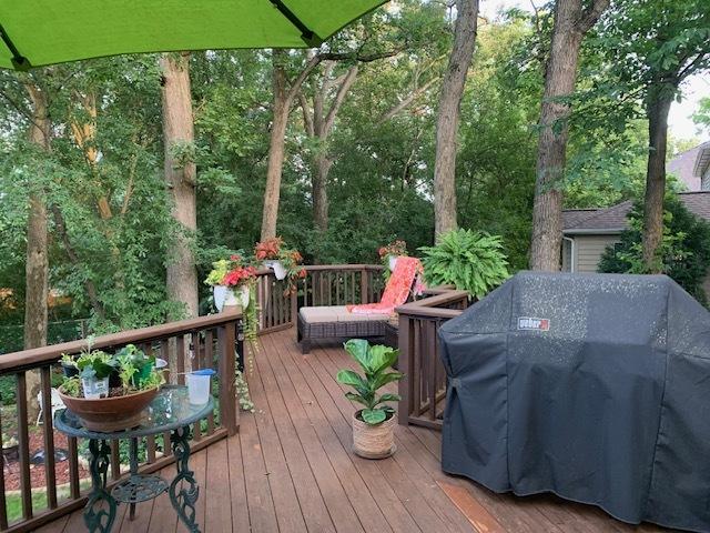 wooden deck featuring a grill