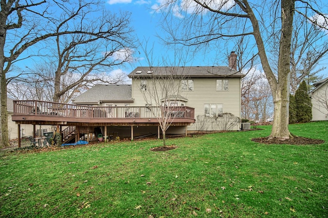 back of property featuring a wooden deck, a yard, and central AC