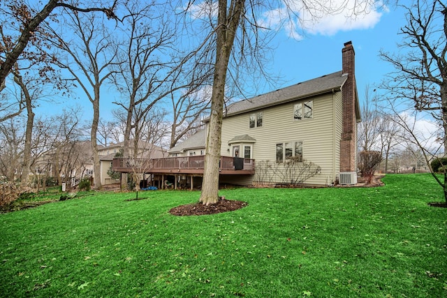 back of house featuring a wooden deck, a yard, and central AC