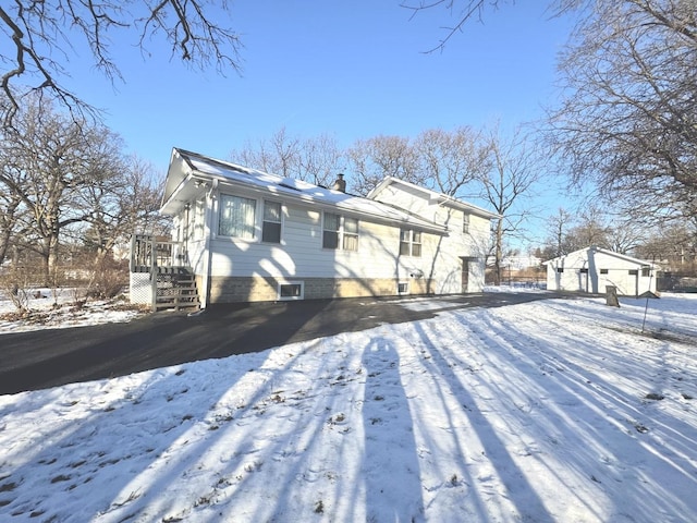 snow covered house with a garage