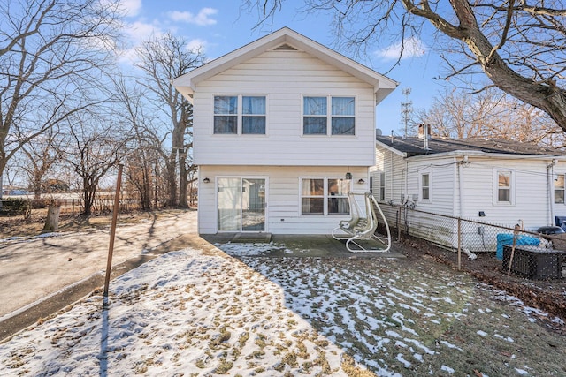 view of snow covered back of property