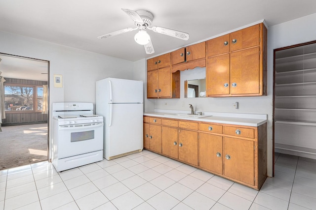 kitchen featuring ceiling fan, sink, light colored carpet, and white appliances