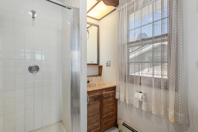 bathroom featuring vanity, a baseboard radiator, and tiled shower