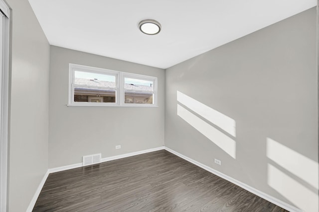 unfurnished room featuring dark hardwood / wood-style floors