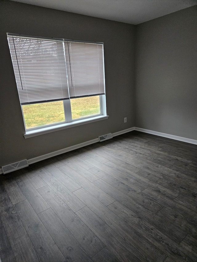 empty room with dark hardwood / wood-style floors