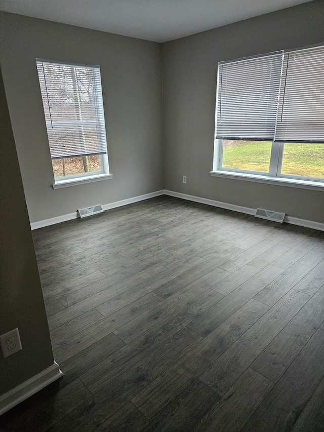 unfurnished room with dark hardwood / wood-style floors