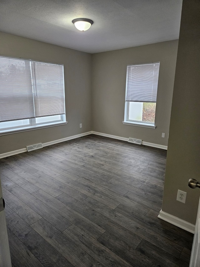 unfurnished room with dark hardwood / wood-style floors