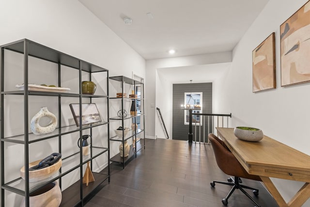 home office featuring an inviting chandelier and dark hardwood / wood-style floors