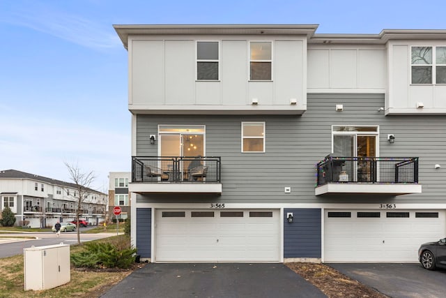 view of front of home with a balcony and a garage