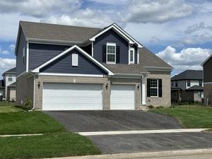 view of front of property featuring a garage and a front lawn