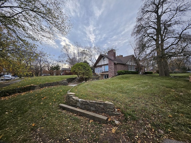 view of side of home with a lawn