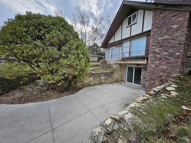 view of side of home featuring a patio area