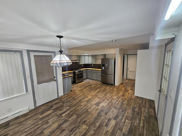 kitchen featuring pendant lighting, appliances with stainless steel finishes, a baseboard heating unit, decorative backsplash, and gray cabinets