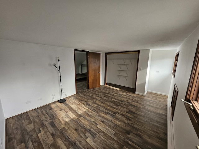 spare room featuring dark wood-type flooring