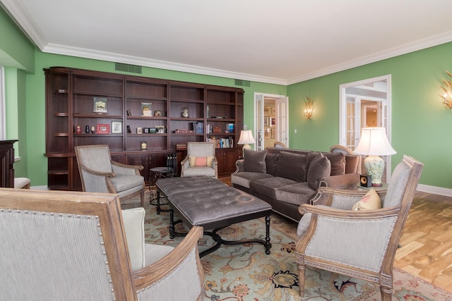 living room featuring crown molding and light hardwood / wood-style flooring