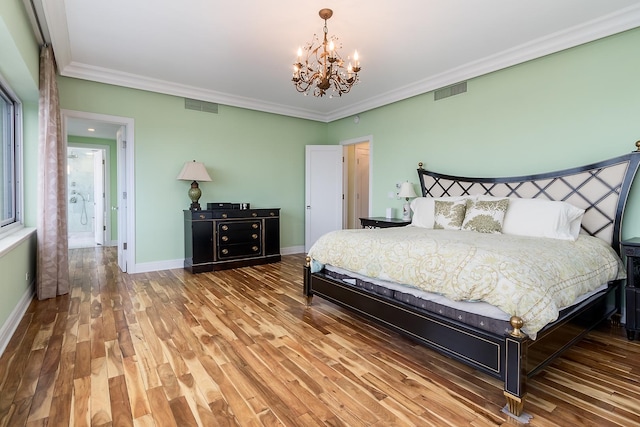 bedroom with hardwood / wood-style flooring, an inviting chandelier, and crown molding