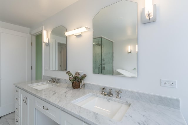 bathroom featuring a shower with door, tile patterned floors, and vanity