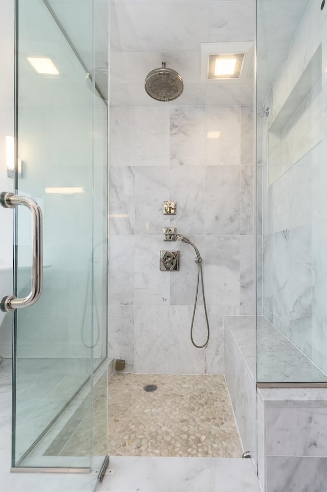 bathroom with a shower with shower door