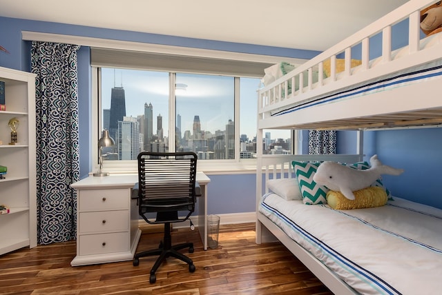 bedroom with dark hardwood / wood-style floors