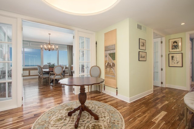 hallway featuring a chandelier and hardwood / wood-style flooring