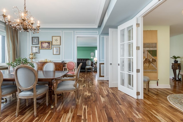 dining area with an inviting chandelier, crown molding, and dark hardwood / wood-style floors