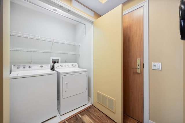 washroom featuring washer and clothes dryer and hardwood / wood-style floors