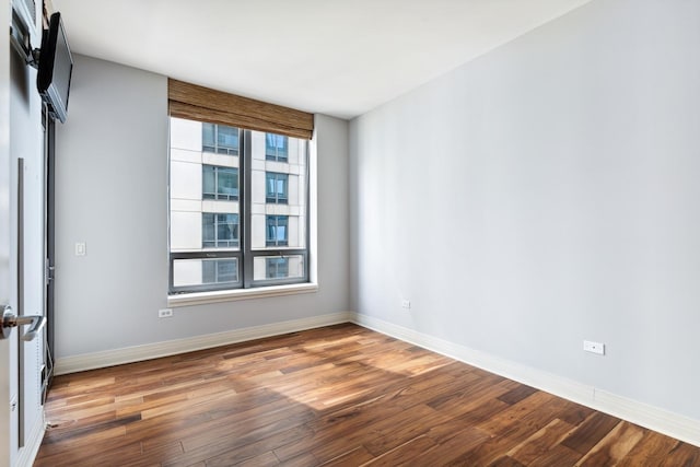 spare room with hardwood / wood-style flooring