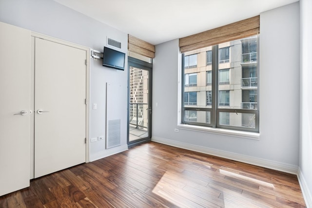 interior space with dark hardwood / wood-style flooring and a wealth of natural light