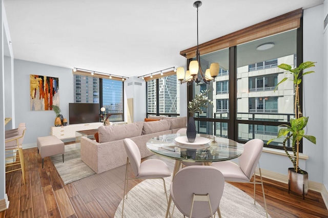 dining space featuring a notable chandelier and wood-type flooring