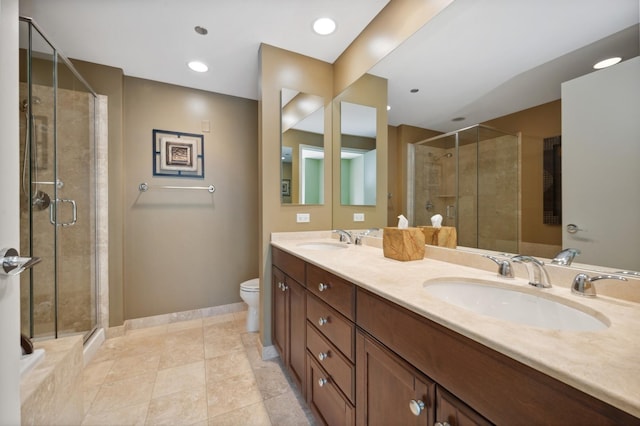 bathroom featuring toilet, tile patterned flooring, an enclosed shower, and vanity